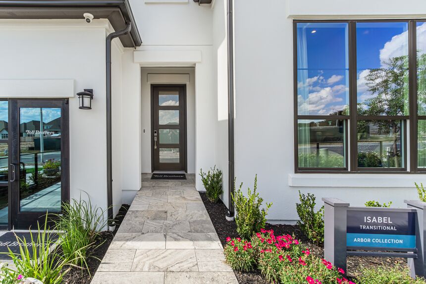 Front walkway leading to the entry door, with flower beds on both sides