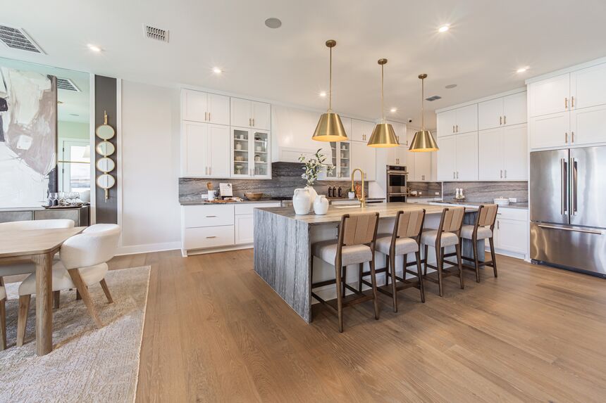 Kitchen island with bar stools and white cabinets